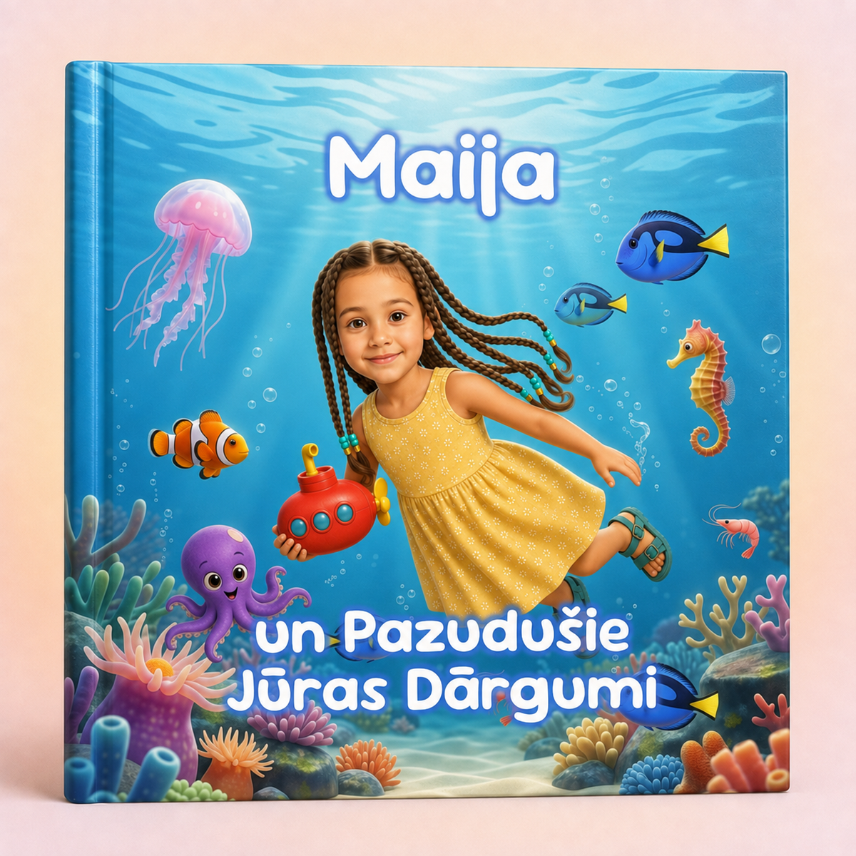 A personalized children's hardcover book titled 'Maija un PazuduŞie Jýras Dărgumi' featuring a colorful underwater illustration with a young girl in a yellow dress, coral reef, sea creatures, and blue text on the cover.