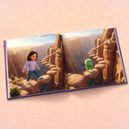 An open hardcover book lying flat on a warm beige background, showing a printed illustration of a girl walking along a canyon ledge with a small green creature on a rock formation.